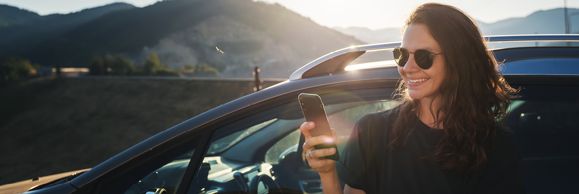 Young woman traveler using her cell phone. 