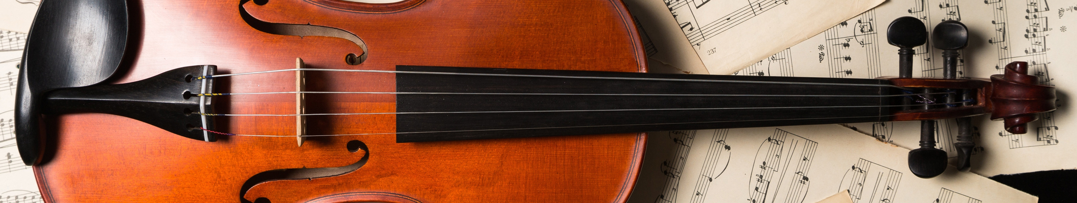 Violin laying on music sheets